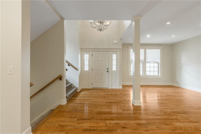 875 Clearview Dr, Lansing, KS 66043 - entrance foyer with light wood-type flooring, stairway, a chandelier, and recessed lighting