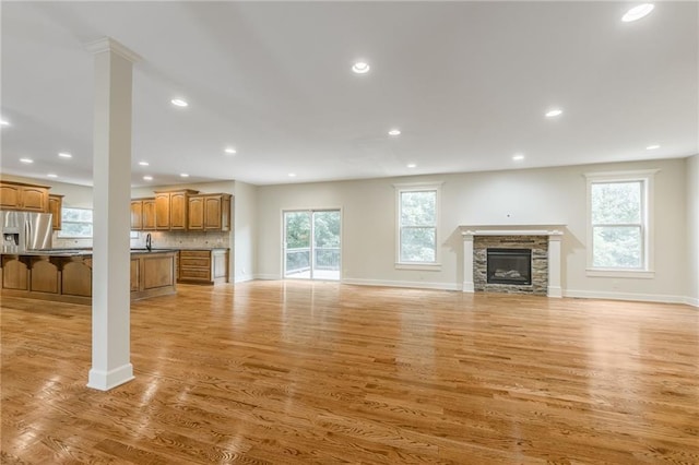 875 Clearview Dr, Lansing, KS 66043 - unfurnished living room featuring a fireplace, light wood-style floors, and recessed lighting