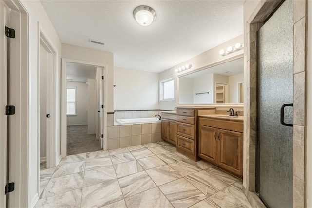 875 Clearview Dr, Lansing, KS 66043 - full bathroom with vanity, a bath, marble finish floors, and a stall shower