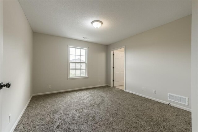 875 Clearview Dr, Lansing, KS 66043 - spare room with carpet floors and a textured ceiling