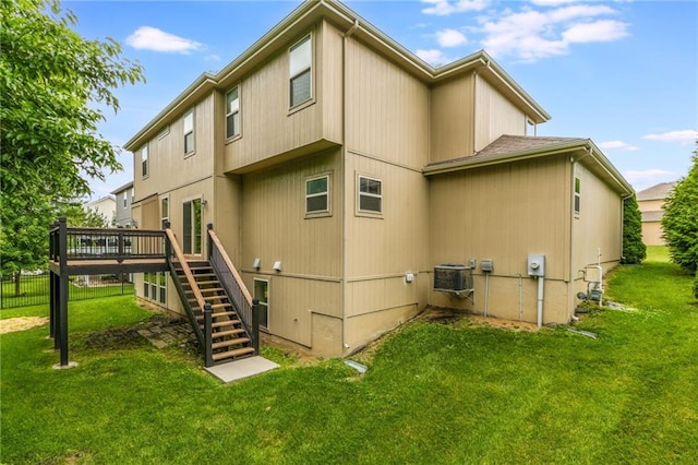 875 Clearview Dr, Lansing, KS 66043 - rear view of property with stairway and a wooden deck