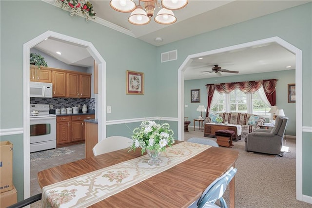 102 W Swenson Dr, Savannah, MO 64485 - dining room with arched walkways, a chandelier, ceiling fan, light carpet, and recessed lighting