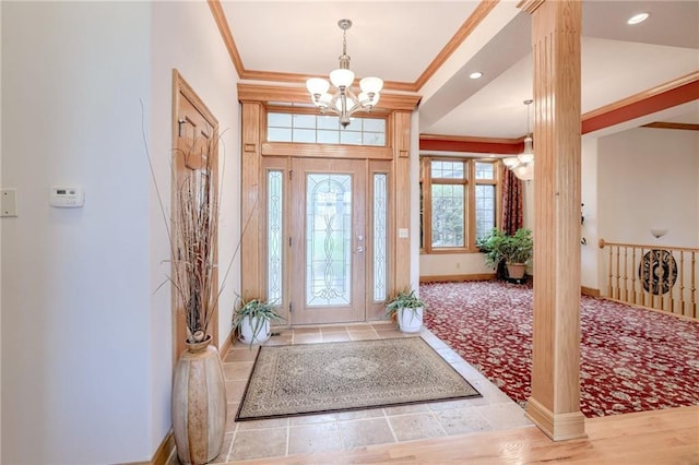 entrance foyer with ornamental molding, a chandelier, baseboards, recessed lighting, and decorative columns