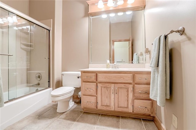 full bathroom featuring toilet, tile patterned flooring, enclosed tub / shower combo, and vanity