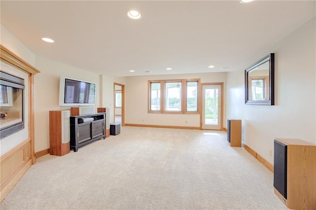 unfurnished living room featuring light colored carpet, recessed lighting, and baseboards