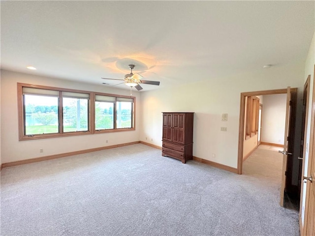 spare room with ceiling fan, light colored carpet, baseboards, and recessed lighting