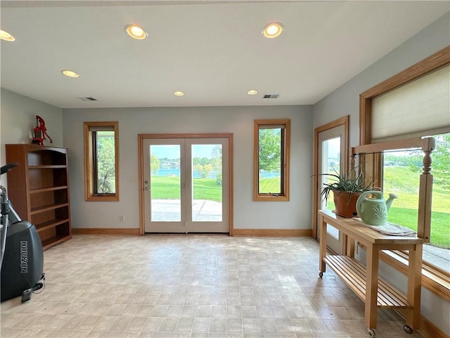 doorway featuring baseboards, plenty of natural light, and recessed lighting