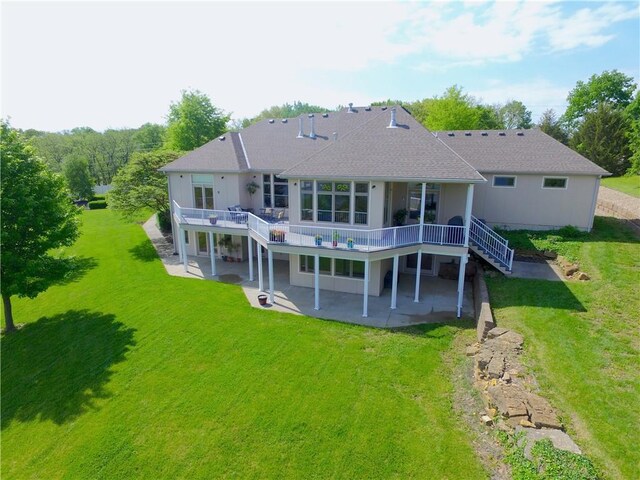 back of house featuring a patio area, a deck, a lawn, stairs, and roof with shingles