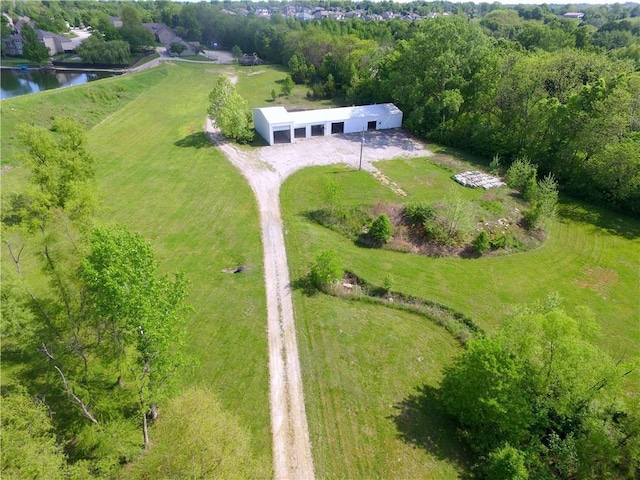 aerial view of property and surrounding area featuring a large body of water