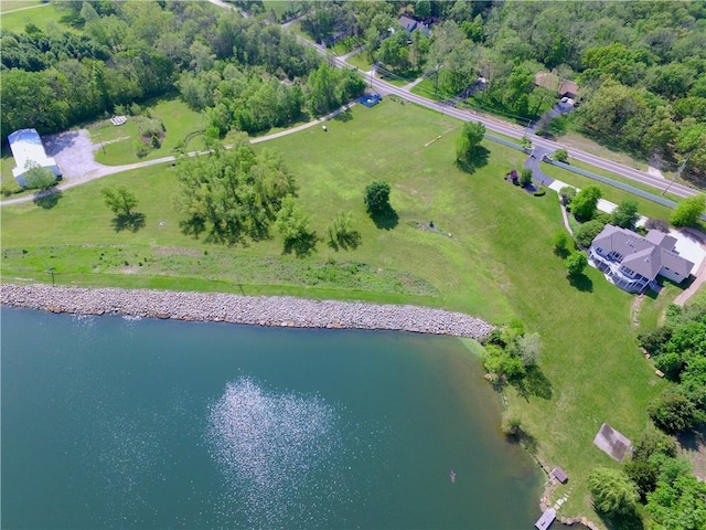 aerial view of property and surrounding area featuring a large body of water