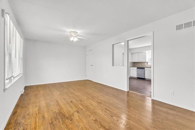 705 NW 88th Ter, Kansas City, MO 64155 - empty room featuring visible vents, baseboards, ceiling fan, and wood finished floors