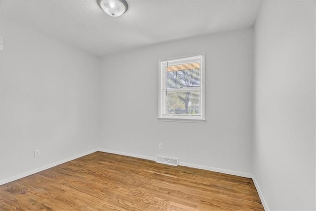 705 NW 88th Ter, Kansas City, MO 64155 - empty room featuring baseboards, visible vents, and wood finished floors