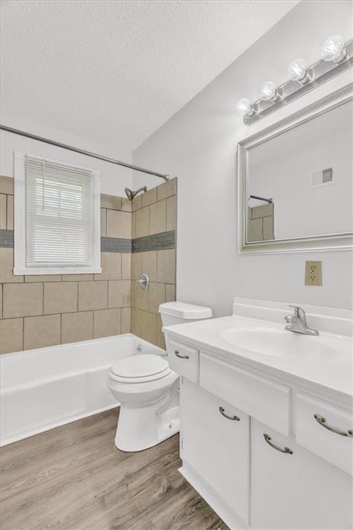 705 NW 88th Ter, Kansas City, MO 64155 - bathroom with a textured ceiling, visible vents, wood finished floors, vanity, and toilet