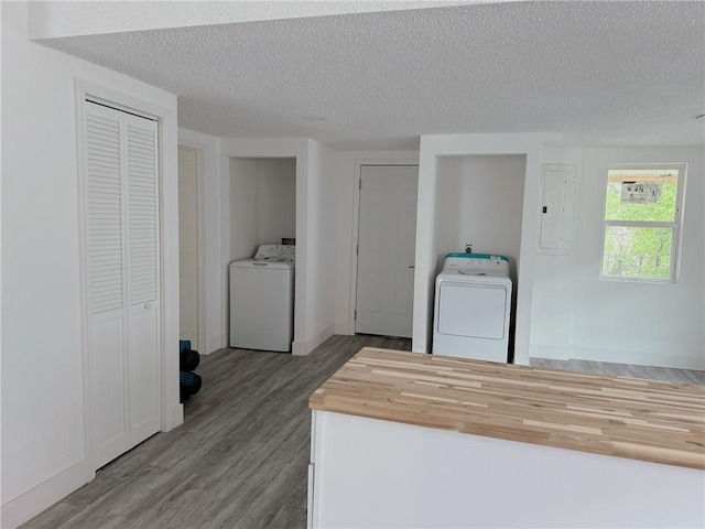 clothes washing area featuring laundry area, a textured ceiling, and washer / clothes dryer