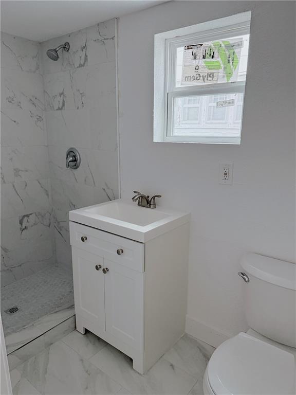 full bath featuring toilet, a shower stall, marble finish floor, and vanity