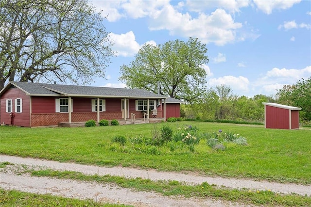 588 NW 105th Rd, Centerview, MO 64019 - single story home featuring covered porch, an outbuilding, a front yard, and a storage unit