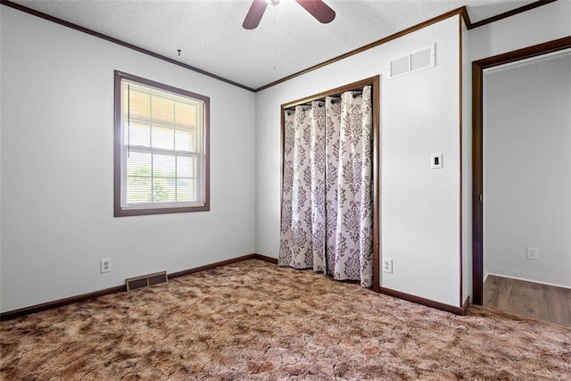 588 NW 105th Rd, Centerview, MO 64019 - unfurnished bedroom featuring crown molding, carpet floors, a textured ceiling, ceiling fan, and baseboards