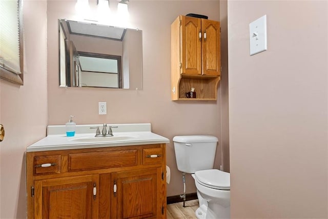 588 NW 105th Rd, Centerview, MO 64019 - bathroom with toilet, vanity, and wood finished floors
