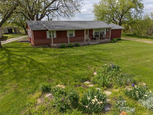 588 NW 105th Rd, Centerview, MO 64019 - ranch-style home with a porch, brick siding, and a front lawn