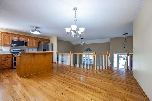 3616 Anchor Ct, Blue Springs, MO 64015 - kitchen with appliances with stainless steel finishes, light wood finished floors, ceiling fan, a chandelier, and brown cabinets