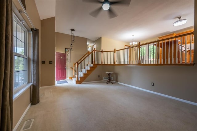 3616 Anchor Ct, Blue Springs, MO 64015 - unfurnished living room with a chandelier, carpet, ceiling fan, and stairway