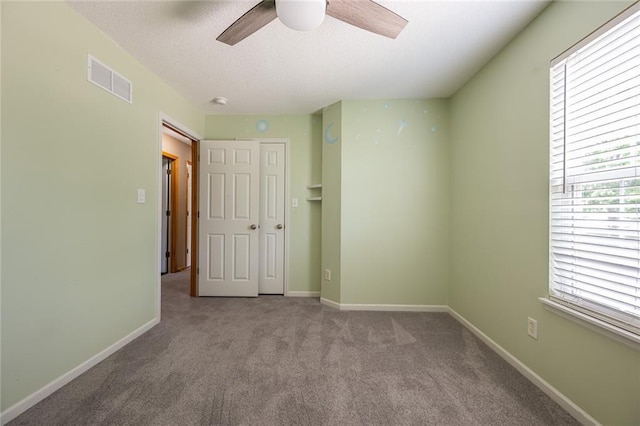 3616 Anchor Ct, Blue Springs, MO 64015 - unfurnished bedroom with a textured ceiling, carpet floors, and ceiling fan