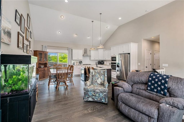living room featuring high vaulted ceiling, dark wood-style floors, and recessed lighting