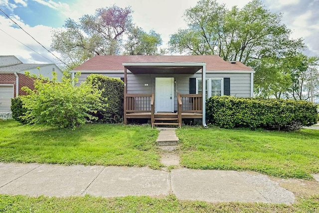 bungalow-style house with covered porch and a front lawn