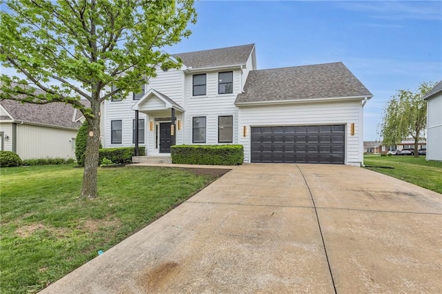 colonial house featuring a garage, a shingled roof, a front yard, and concrete driveway