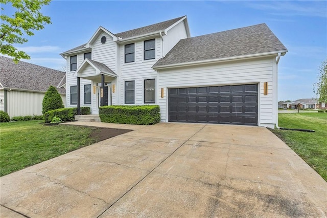 colonial home featuring an attached garage, a front lawn, roof with shingles, and driveway