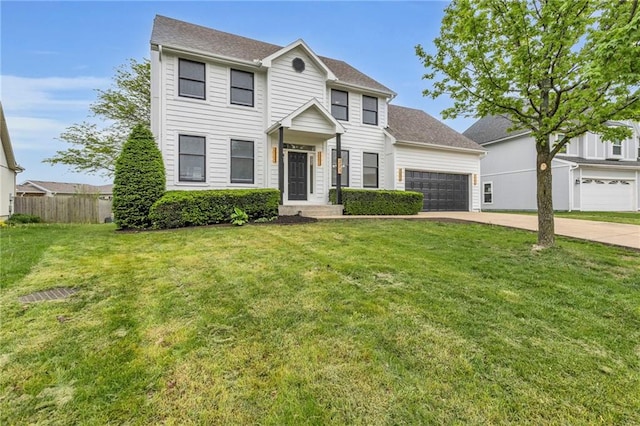colonial-style house with an attached garage, a front lawn, fence, and concrete driveway