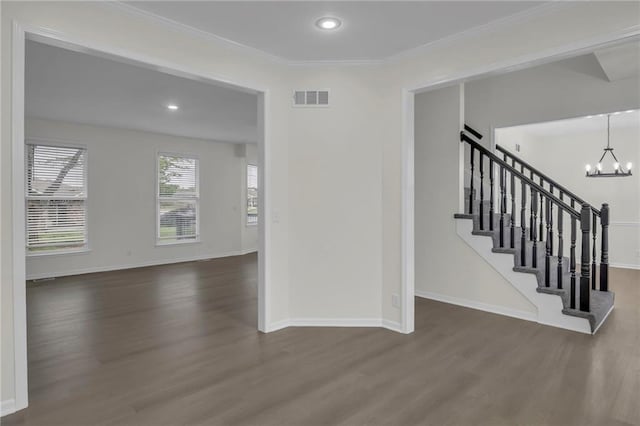 interior space featuring visible vents, baseboards, wood finished floors, and a notable chandelier