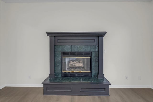 interior details featuring baseboards and wood finished floors