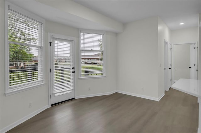 spare room with baseboards, recessed lighting, and wood finished floors