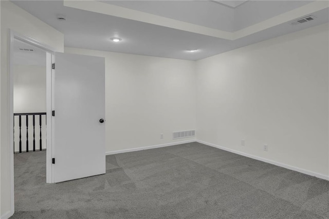 empty room with baseboards, carpet, and visible vents