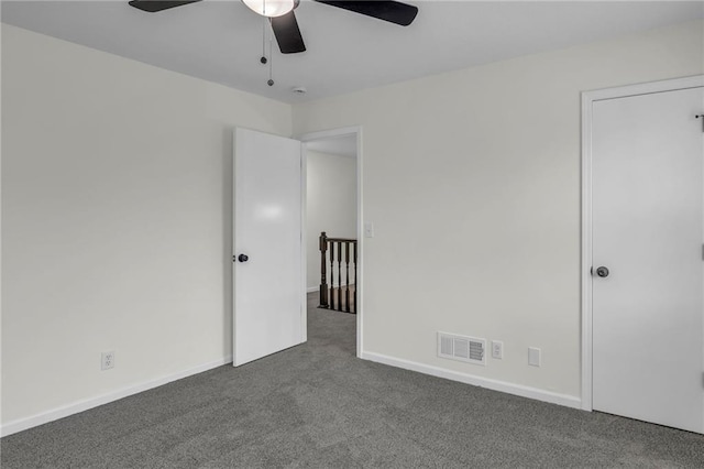 interior space featuring baseboards, carpet, a ceiling fan, and visible vents