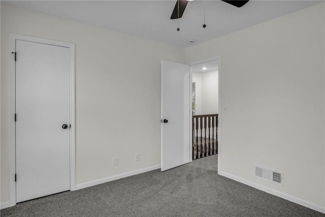 unfurnished bedroom with baseboards, ceiling fan, carpet flooring, and visible vents