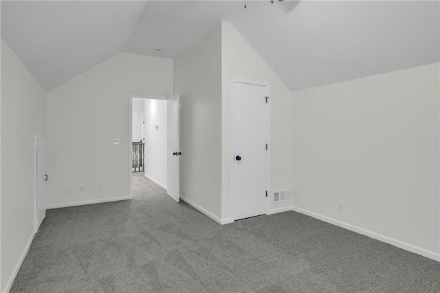 additional living space with carpet flooring, baseboards, visible vents, and lofted ceiling