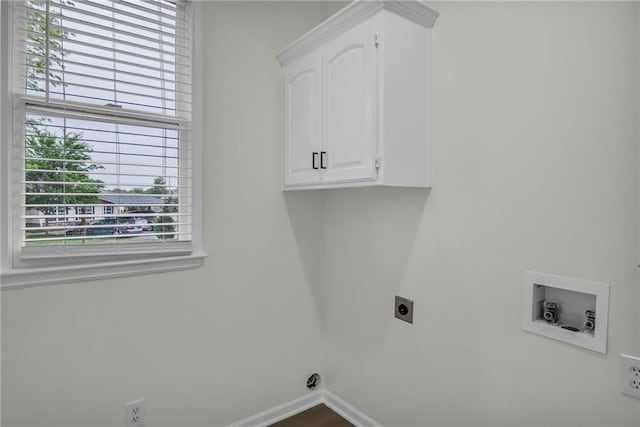 laundry room featuring plenty of natural light, cabinet space, washer hookup, and hookup for an electric dryer