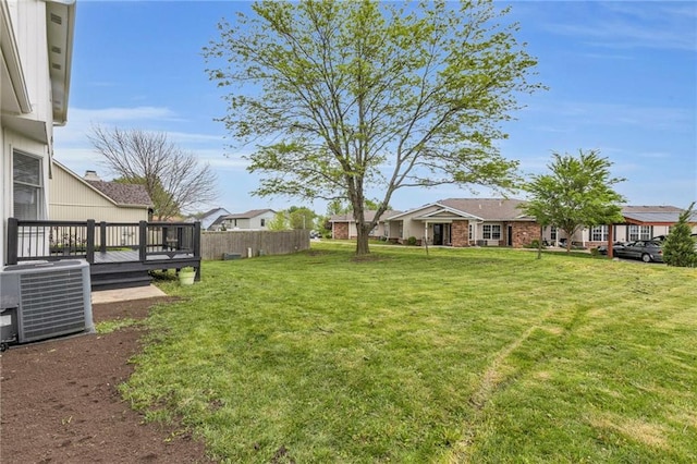 view of yard with fence, a residential view, cooling unit, and a wooden deck