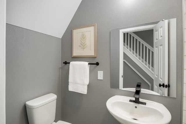 157 Clark Ave, Bonner Springs, KS 66012 - half bath featuring a sink, toilet, and lofted ceiling