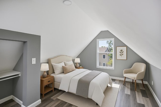 157 Clark Ave, Bonner Springs, KS 66012 - bedroom featuring vaulted ceiling, wood finished floors, and baseboards