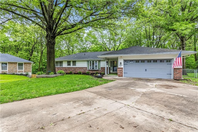 8739 Lafayette Ave, Kansas City, KS 66109 - ranch-style home with brick siding, concrete driveway, a garage, and view of scattered trees