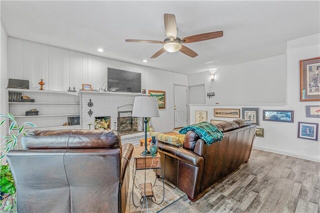 8739 Lafayette Ave, Kansas City, KS 66109 - living area with wood finished floors, ceiling fan, a fireplace, and recessed lighting