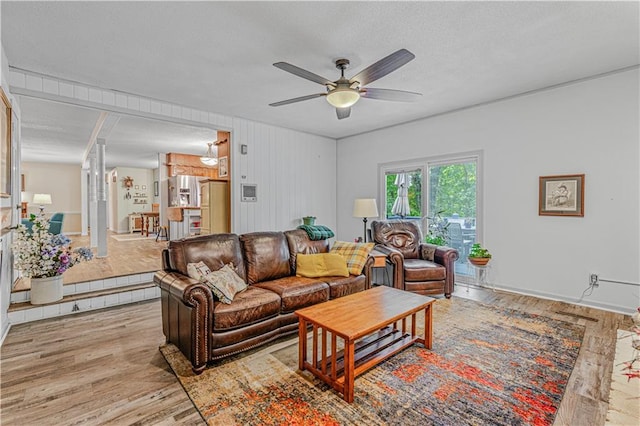 8739 Lafayette Ave, Kansas City, KS 66109 - living area featuring a ceiling fan, light wood-style floors, and a textured ceiling