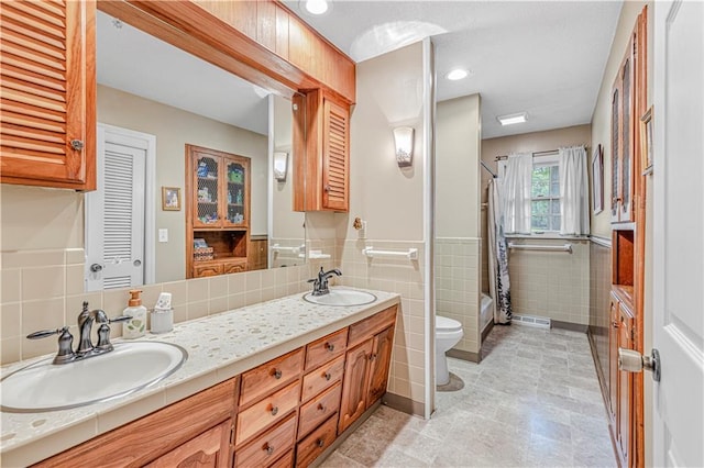 8739 Lafayette Ave, Kansas City, KS 66109 - full bathroom with tile walls, toilet, double vanity, and shower / bath combination with curtain