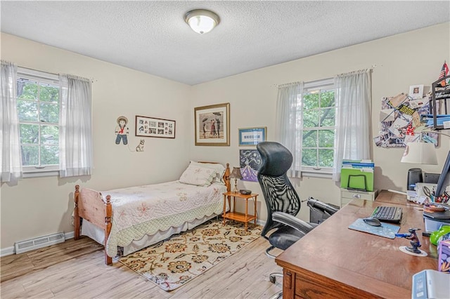 8739 Lafayette Ave, Kansas City, KS 66109 - bedroom with wood finished floors, multiple windows, a textured ceiling, an office area, and baseboards