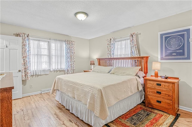 8739 Lafayette Ave, Kansas City, KS 66109 - bedroom with light wood-style flooring, baseboards, and a textured ceiling