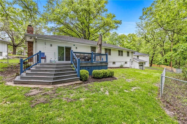 8739 Lafayette Ave, Kansas City, KS 66109 - back of property with a chimney and a wooden deck