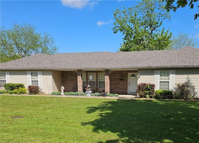 single story home featuring brick siding and a front lawn